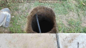Photo showing a sprinkler line in a basketball hole installed by Precise Assemblies.